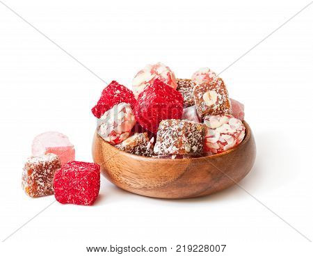 Assortment turkish delight in wooden plate isolated on white