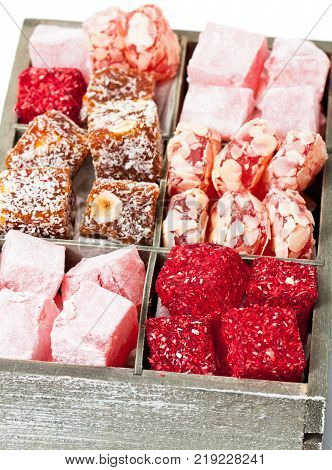 Assortment turkish delight in wooden box isolated on white