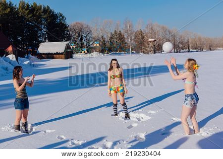 Novokuznetsk, Kemerovo region, Russia-23 Feb, 2017: White beaches of Siberia is an enterteiment activity where people playing beach games dressed in bikini in winter. Women playing volleyball on snow