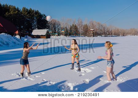 Novokuznetsk, Kemerovo region, Russia-23 Feb, 2017: White beaches of Siberia is an enterteiment activity where people playing beach games dressed in bikini in winter. Women playing volleyball on snow
