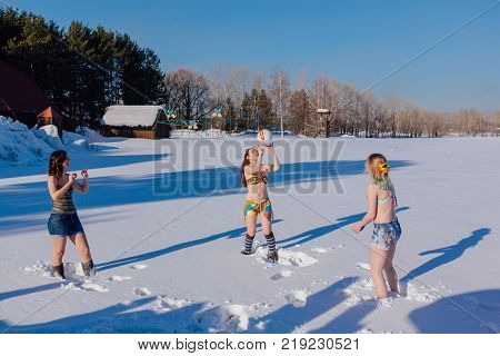 Novokuznetsk, Kemerovo region, Russia-23 Feb, 2017: White beaches of Siberia is an enterteiment activity where people playing beach games dressed in bikini in winter. Women playing volleyball on snow