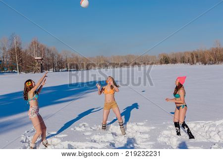 Novokuznetsk, Kemerovo region, Russia-23 Feb, 2017: White beaches of Siberia is an enterteiment activity where people playing beach games dressed in bikini in winter. Women playing volleyball on snow