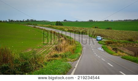 Hokkaido Japan - Oct 2 2017. A car stopping on rural road in Hokkaido Japan. Hokkaido is the second largest island of Japan and the northernmost prefecture.