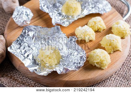Frozen grated ginger in foil. Freezing food.