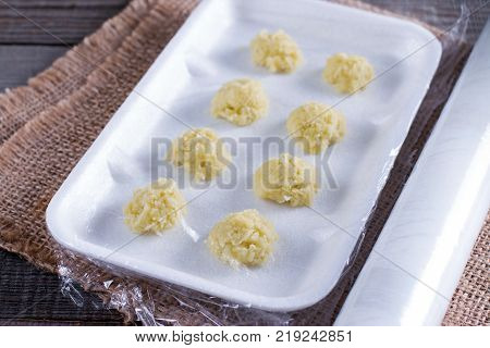 Frozen grated ginger on old wooden planks on a wooden table