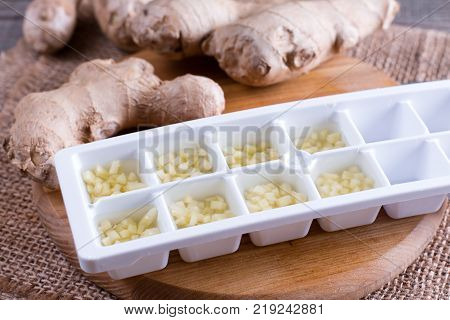 Frozen grated ginger on old wooden planks