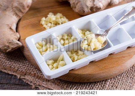 Pieces of ginger in a container for freezing ice cubes