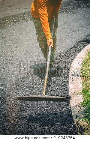 Worker Uses Vibratory Plate Compactor Compacting Asphalt At Road Repair