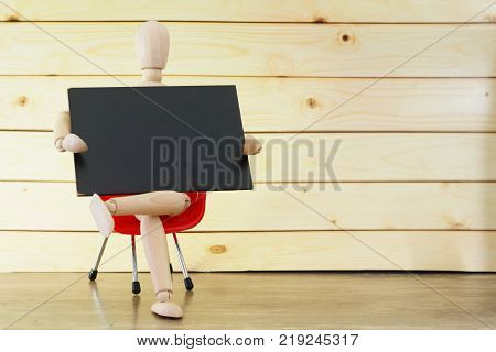 Your Text Here :Dummy / ball-jointed doll holding blank mini blackboard while sitting on red chair