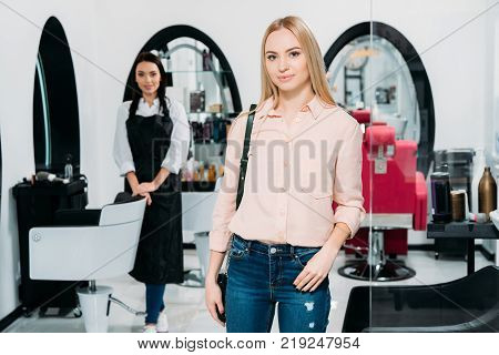 attractive hair salon customer standing and looking at camera