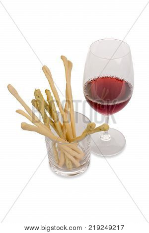 A glass of red wine with Italian sticks in a glass on a white background