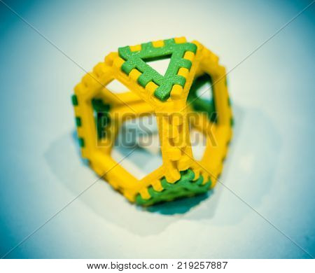 Abstract object of a color printed by 3d printer on white background. Fused deposition modeling, FDM. Progressive modern additive technology. Concept of 4.0 industrial revolution