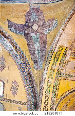 ISTANBUL, TURKEY - OCTOBER 30, 2015: Interior of Hagia Sophia Dome with fresco of Hexapterygon - six-winged Seraphim, biblical angel. Structure was formerly basilica, mosque, and now museum