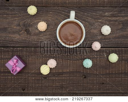 Freshly brewed cocoa and colorful bee on an old wooden table