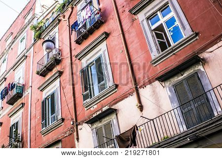Alley between crowded neighborhoods. typical Neapolitan palace with washed clothes hung to dry on clothesline.