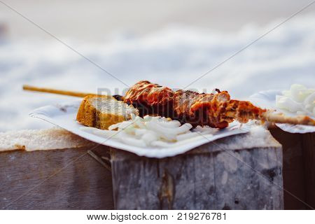 Barbecue cooking - half done kebab of marinated pork, onion and tomatos