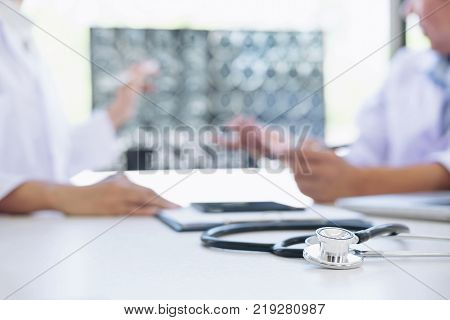 Professor Doctor discussion a method with patient treatment results on brain x-ray film About the problem of the patient.