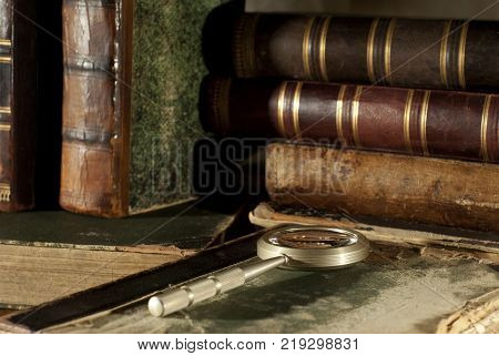 ancient books book with a cracked leather spine and green patterned binding isolated