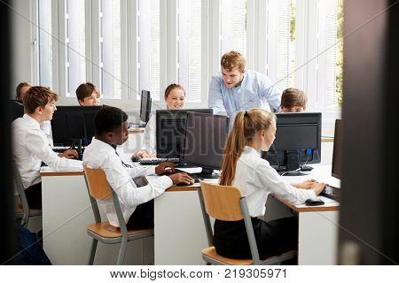 Teenage Students Wearing Uniform Studying In IT Class