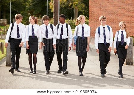 Group Of Teenage Students In Uniform Outside School Buildings