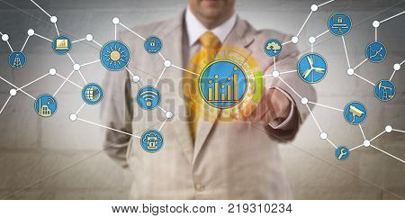 Unrecognizable corporate manager optimizing energy consumption via the Internet of Things. Information technology and sustainability concept for remote energy management over a cloud based interface.