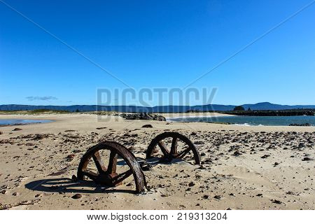 corroded axle tree stuck in beach sand