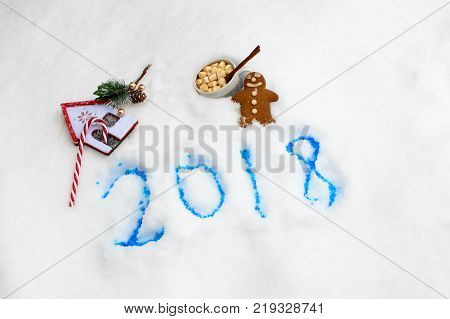 Happy New Year 2018 seasons greeting card for sending wishes in 2017 2018 fun holiday New Year's with Christmas Candy Cane, hot chocolate with marshmallows and gingerbread man traditional vintage items conceptual background, evergreen and gold berry ornam