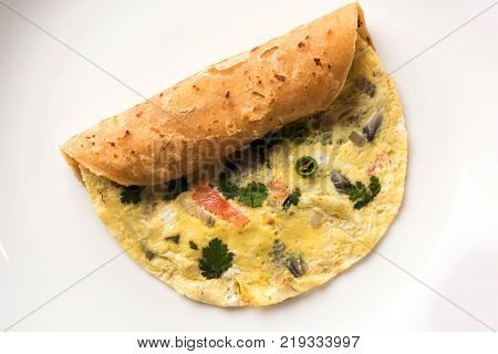 omelette / omelette chapati roll or Indian bread or roti rolled with omlet. Popular, quick and healthy recipe for kid's tiffin or lunch box