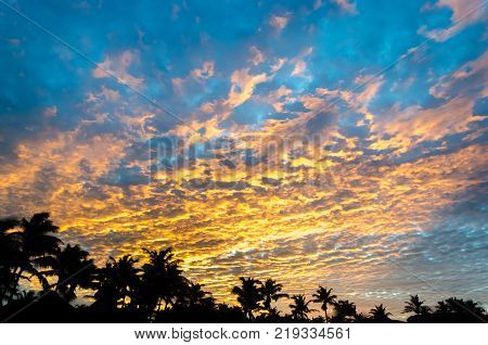 Sunset At The Beach With Tourists Enjoying
