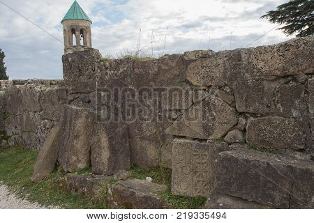 The broken city walls of the ancient Georgian city. Ancient inscriptions carved in the stone. Old Ruined Farmstead and Stone Walls