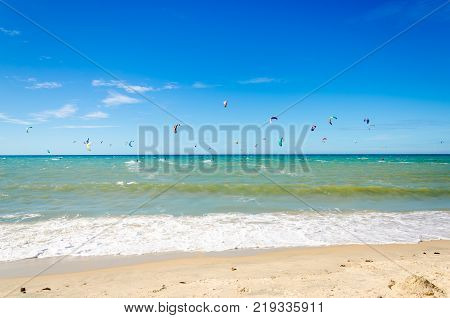 Sunset At The Beach With Tourists Enjoying