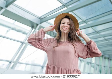 Young woman in international airport walking with her luggage.