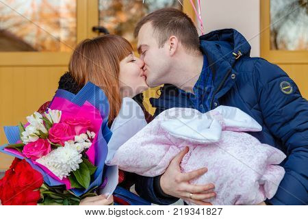 Grodno Belarus - December 13 2017: Happy father meets his wife with a newborn baby in perinatal center of Grodno city.