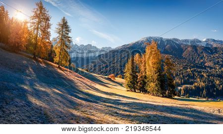Panorama of the Santa Maddalena village's slopes in front of the Geisler or Odle Dolomites Group. Colorful autumn sunrise in Dolomite Alps Italy Europe. Artistic style post processed photo.