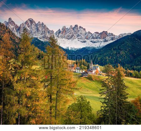 Magnificent view of Santa Maddalena village in front of the Geisler or Odle Dolomites Group. Colorful autumn sunset in Dolomite Alps Italy Europe. Artistic style post processed photo.