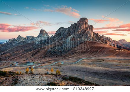 Fantastic morning view from the top of Giau pass with famous Ra Gusela Nuvolau peaks in background. Colorful autumn sunrise in Dolomite Alps Cortina d'Ampezzo location Italy Europe.