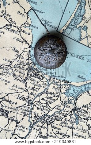ILLUSTRATIVE EDITORIAL.Polish Army insignia (found with metal detector near Kiev).German vintage map of Central Europe circa 1944 fragment.Poland under occupation.
Kiev,Ukraine December 22 ,2017