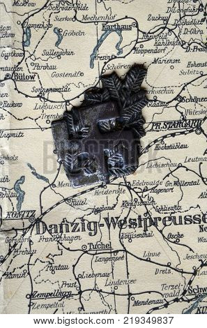ILLUSTRATIVE EDITORIAL.Polish Army insignia (found with metal detector near Kiev).German vintage map of Central Europe circa 1944 fragment.Poland under occupation.
Kiev,Ukraine December 22 ,2017