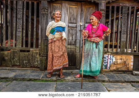 BANDIPUR, NEPAL - OCTOBER 22, 2015 : Two very old women discuss in the street of Bandipur in Nepal