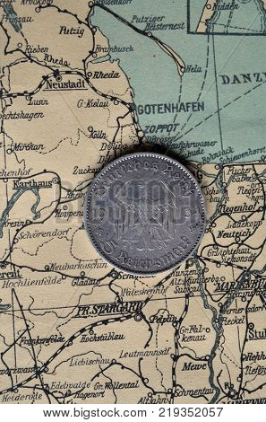 ILLUSTRATIVE EDITORIAL.German vintage coin.Background - German vintage map of Central Europe circa 1944 fragment.
Kiev,Ukraine December 22 ,2017