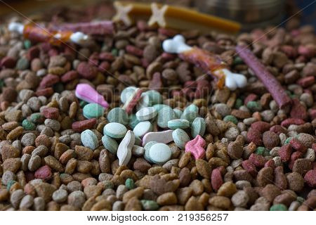 Vitamin tablets for pets on hip of dry pet food