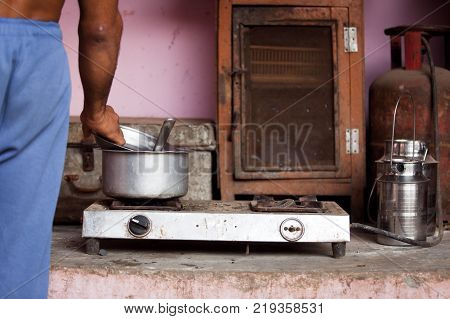 a hotplate and cooking utensils in a courtyard in delhi, india