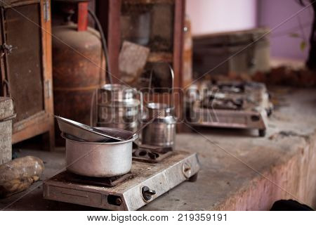 a hotplate and cooking utensils in a courtyard in delhi, india