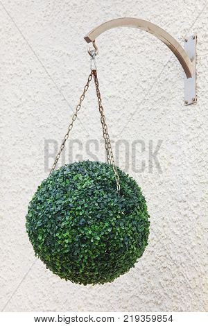 Green ball hangs from the ceiling in the restaurant hall