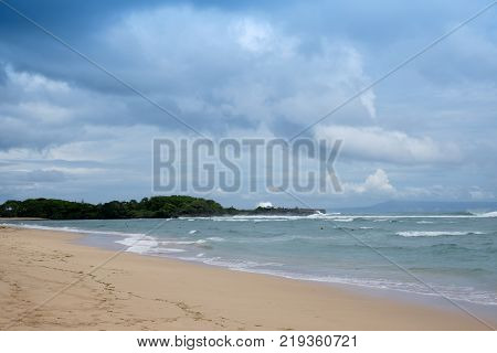 Nuca Dua beach with cloudy sky and clean water on Bali Indonesia. Beautiful beach to spend vacation and rest