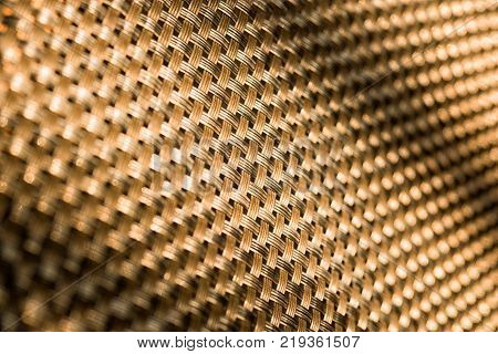 Abstract pattern or background. Gold diagonal grid closeup.