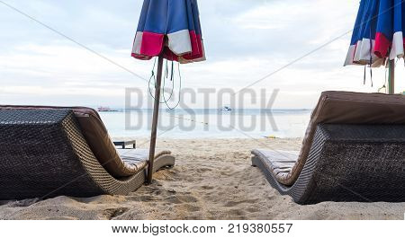Beautiful beach. Sunbeds with umbrella on the sandy beach near the sea. Summer holiday and vacation concept. Inspirational tropical beach.