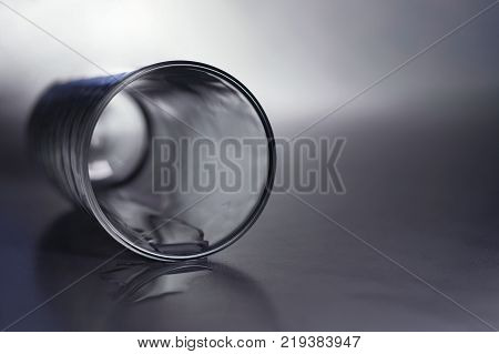 an empty glass lying on one side on a gray table close-up