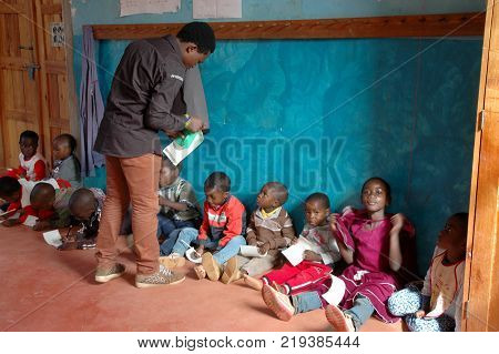25 October 2017-Franciscan Center of Pomerini-Tanzania-Africa-A group of unidentified African children follow the after-school lessons helped by some unidentified members of a non-profit association