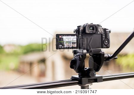 dslr mirrorless camera on tripod with video fluid head